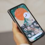 In simple background holding the Pixel 9 Pro fold and showing the display quality